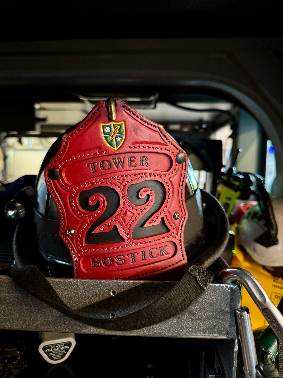 Red leather patch with 'Tower 22 Bostick' on a vehicle interior.