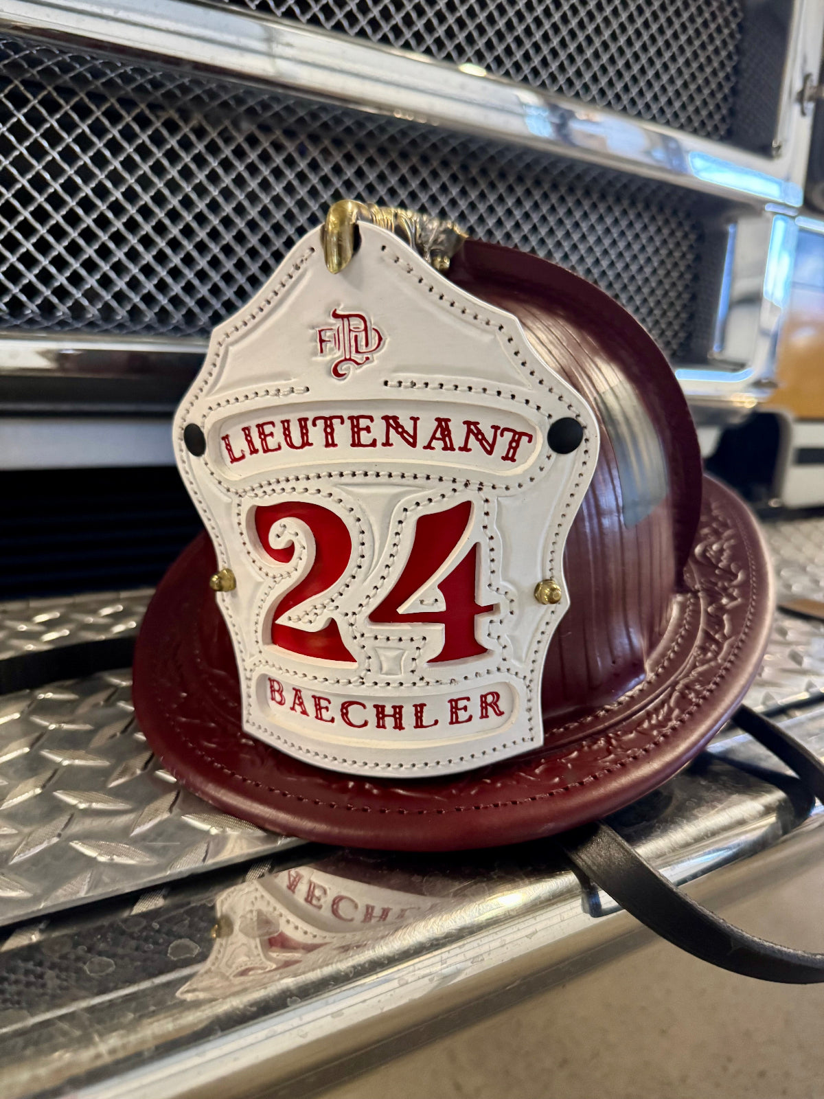 Close-up of a badge with '24' and 'Bachler' text on a metallic background